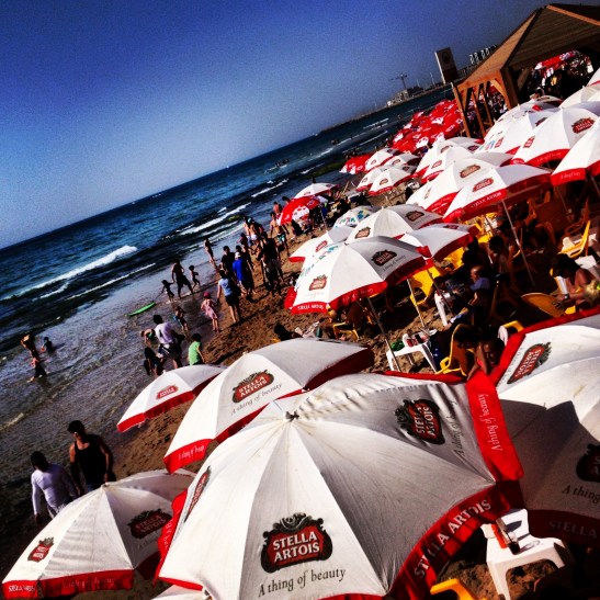 Weekend umbrellas fill the beach